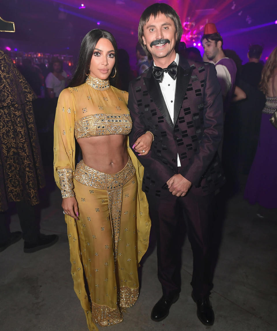 Kim Kardashian paid homage to her favorite style icon, Cher, as she kicked off Halloween weekend with Jonathan Cheban. (Photo: Getty Images)