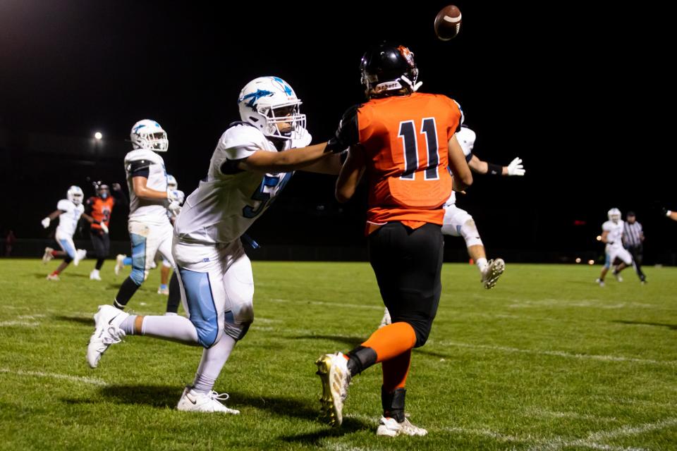 Diman’s Sam Perry just gets the ball out of his hand as Seekonk’s Lucas Figueiredo applies pressure during a recent game on Friday night.