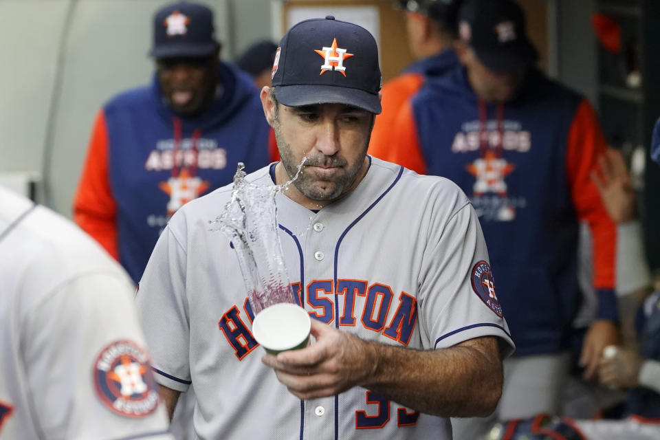 Houston Astros starting pitcher Justin Verlander tosses a cup of water in the dugout after the first inning of the team's baseball game against the Seattle Mariners, Friday, May 27, 2022, in Seattle. Verlander gave up four runs on two home runs by the Mariners during the inning. (AP Photo/Ted S. Warren)