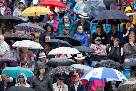 Tennis - WTA Premier - Aegon International - Devonshire Park Lawn Tennis Club, Eastbourne, Britain - June 27, 2017 Fans with umbrellas as rain stops play Action Images via Reuters/Matthew Childs