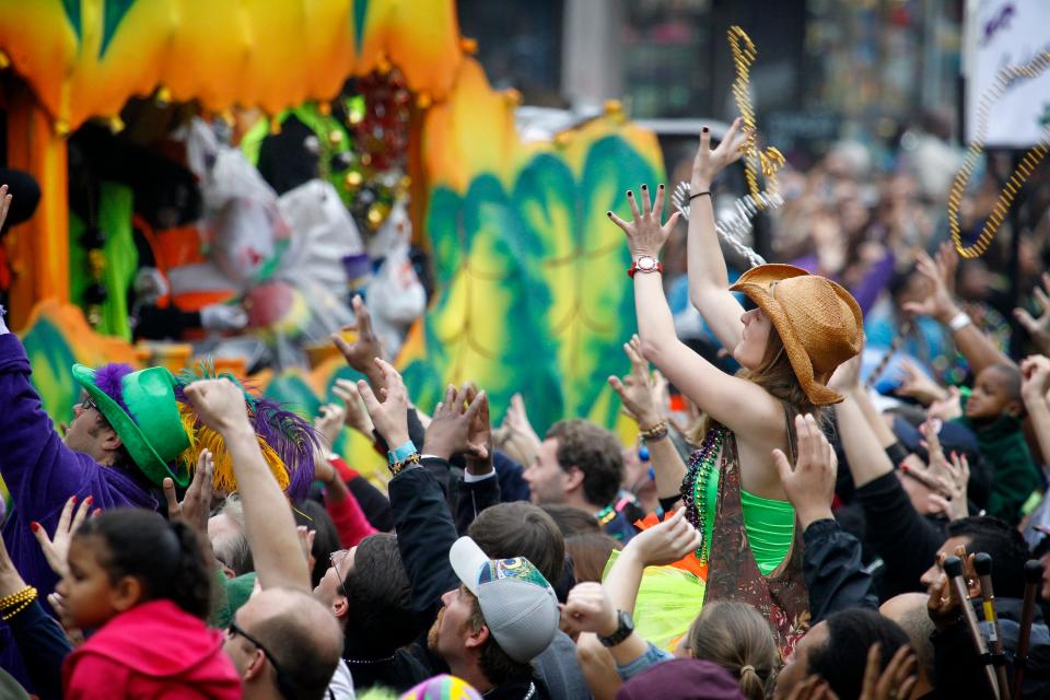 A parade goer catches a pair of beads tossed from a float in the Krewe of Zulu parade on Mardi Gras Day. Fat Tuesday, the traditional celebration on the day before Ash Wednesday and the begininng of Lent, is marked in New Orleans with parades and marches through many neighborhoods in the city.