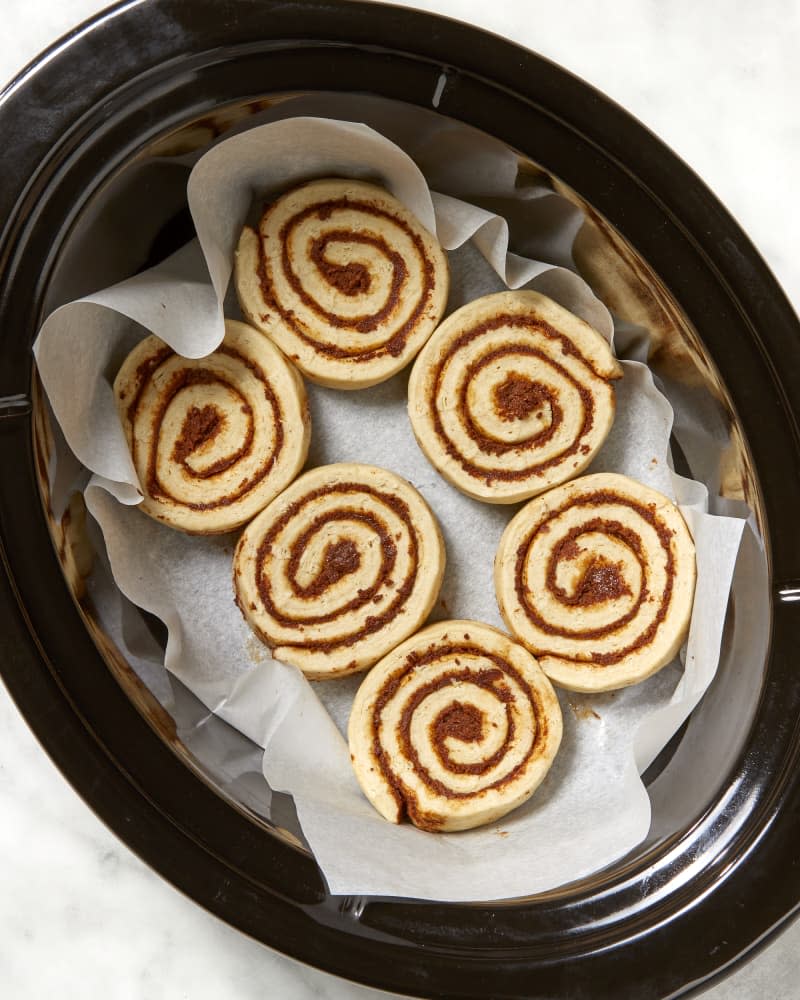 Overhead shot of unbaked cinnamon rolls in a slow cooker.