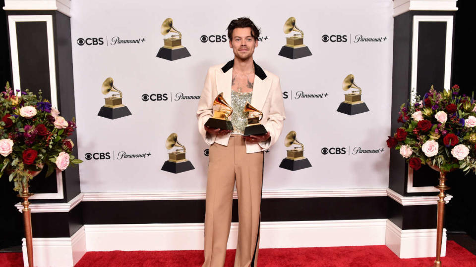 LOS ANGELES, CALIFORNIA - FEBRUARY 05: Harry Styles poses with the Best Pop Vocal Album Award for “Harry’s House” and Album of the Year Award for “Harry’s House” in the press room during the 65th GRAMMY Awards at Crypto.com Arena on February 05, 2023 in Los Angeles, California.   Alberto E. Rodriguez/Getty Images for The Recording Academy/AFP (Photo by Alberto E. Rodriguez / GETTY IMAGES NORTH AMERICA / Getty Images via AFP)