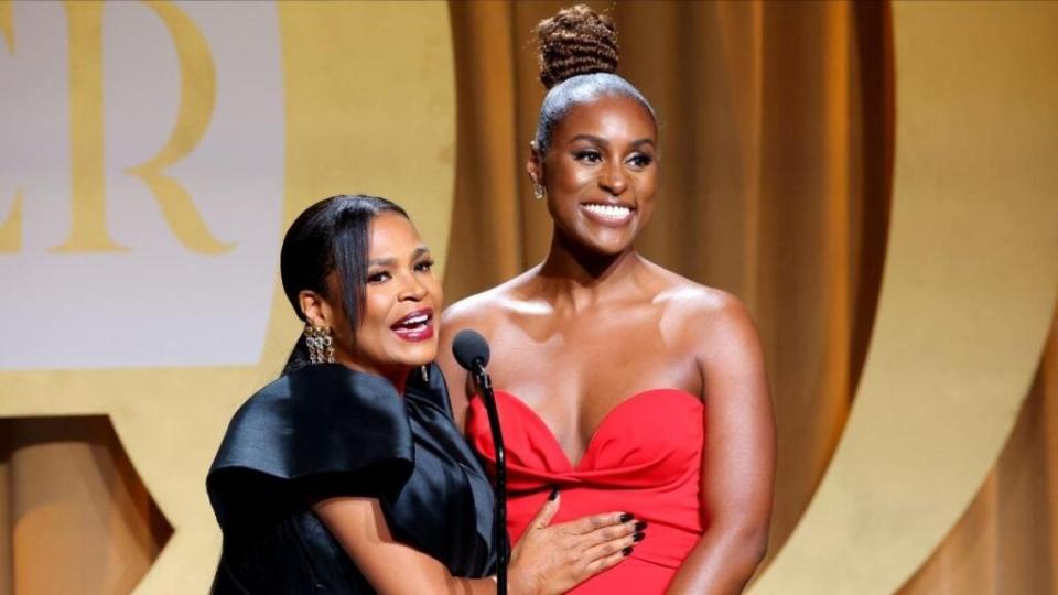 Issa Rae (Right) accepts the People’s Choice Award from Nia Long onstage during EBONY Power 100 at Milk Studios in Los Angeles, California.