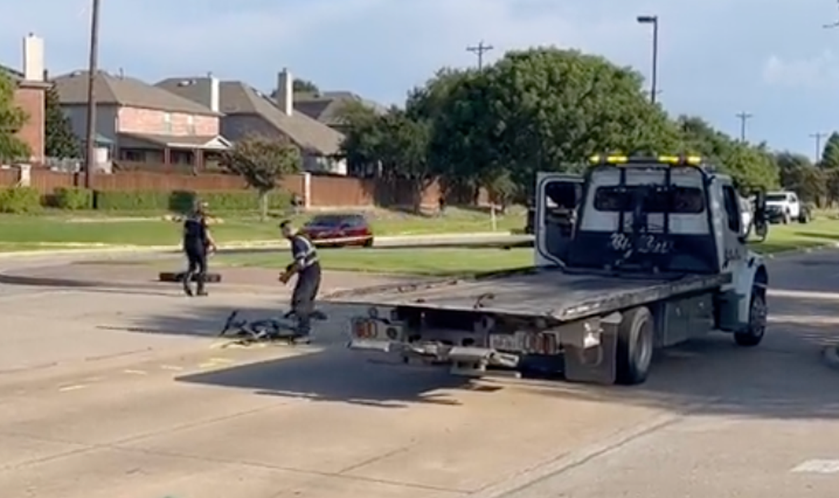 Officials remove a 15-year-old student’s bike after he was struck and killed on the first day of school in Frisco, Texas (NBC5)