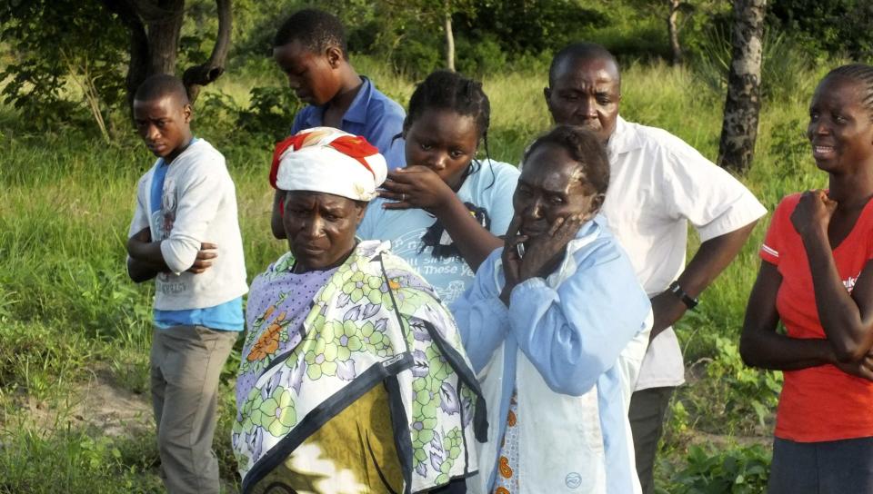 Residents mourn relatives who were killed when gunmen attacked Hindi village, near Lamu