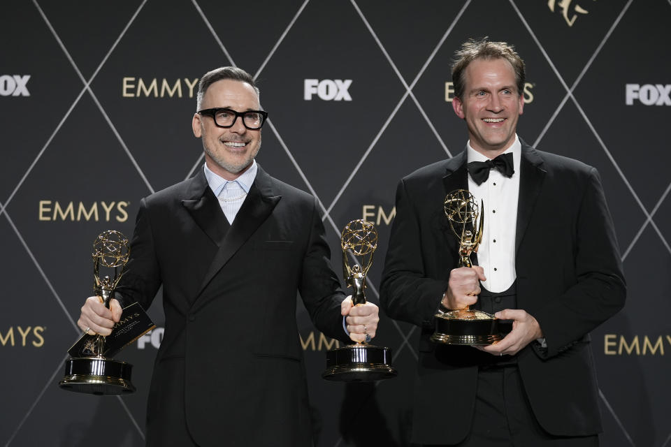 David Furnish, left, and Luke Lloyd Davies, winners of the award for outstanding variety special lLive) for "Elton John Live: Farewell From Dodger Stadium," pose in the press room during the 75th Primetime Emmy Awards on Monday, Jan. 15, 2024, at the Peacock Theater in Los Angeles. (AP Photo/Ashley Landis)