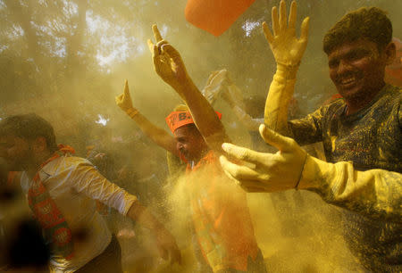 Supporters of India’s Bharatiya Janata Party (BJP) celebrate after learning of the initial poll results outside the party headquarters in New Delhi, India, March 11, 2017. REUTERS/Adnan Abidi