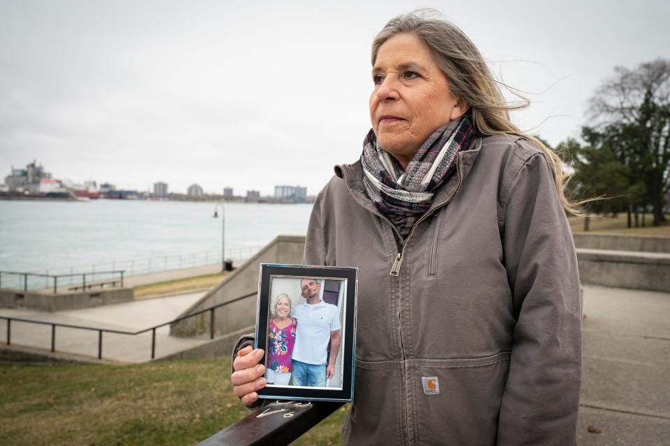 Katie Tanton of Port Huron holds a photo of her and her son, Bobby McIntyre, at Pine Grove Park in Port Huron on Friday, March 15, 2024. Tanton is the plaintiff in a lawsuit regarding issues with being able to contact her son, who is incarcerated at the St. Clair County Jail.