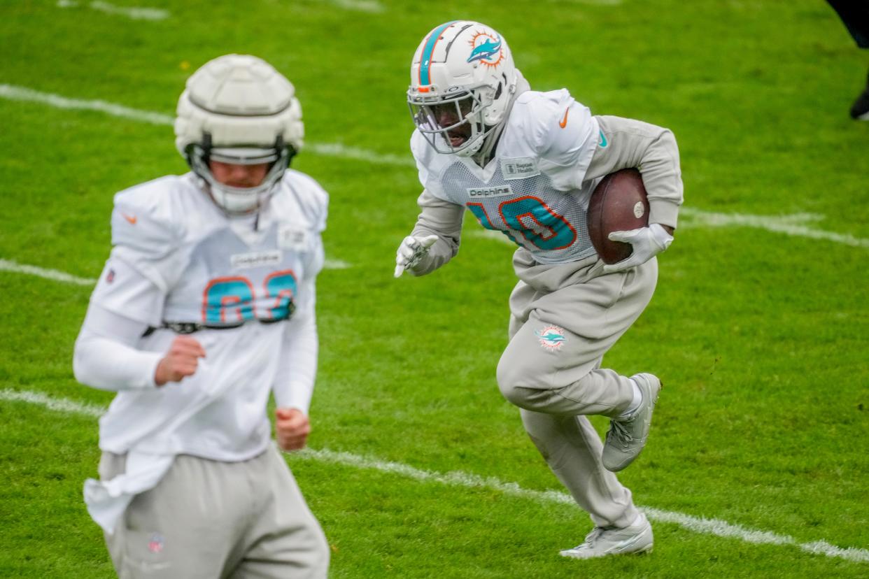 Miami Dolphins wide receiver Tyreek Hill, right, runs with the ball during a practice session in Frankfurt, Germany, Thursday, Nov. 2, 2023. The Miami Dolphins are set to play the Kansas City Chiefs in an NFL game in Frankfurt on Sunday Nov. 5, 2023. (AP Photo/Michael Probst)