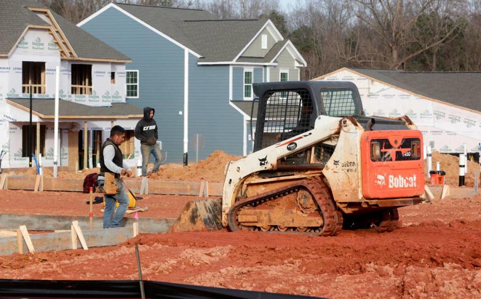 A construction crew works on a site at the new Lennar Elizabeth subdivision off the Fort Mill Parkway on Saturday, Jan. 21, 2023.