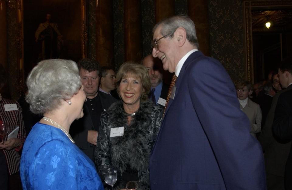 The Queen with Jennie Bond and Denis Norden at a 2001 reception in Buckingham Palace (PA)