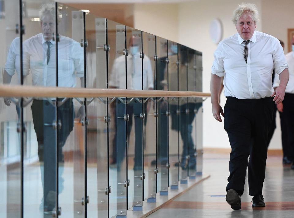 Britain's Prime Minister Boris Johnson walks along a corridor during a visit to Hexham General Hospital on November 8, 2021 in Hexham in northern England. - Prime Minister Boris Johnson faced pressure to appear before British lawmakers debating the standards system Monday, as days of sleaze and cronyism claims against his government intensified with new revelations. (Photo by Peter Summers / POOL / AFP) (Photo by PETER SUMMERS/POOL/AFP via Getty Images)