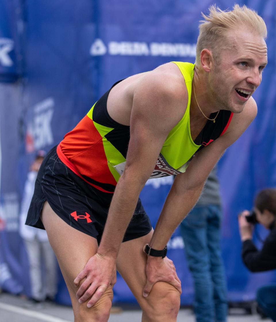 Jacob Thomson leans down after his third-place finish in the Mini Marathon in Indianapolis in May.