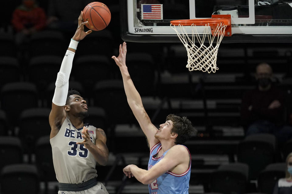 Shawnee State forward EJ Onu (35) shoots over Lewis-Clark State forward Trystan Bradley during the first half of the final of the NAIA men's basketball tournament in Kansas City, Mo., Tuesday, March 23, 2021. (AP Photo/Orlin Wagner)