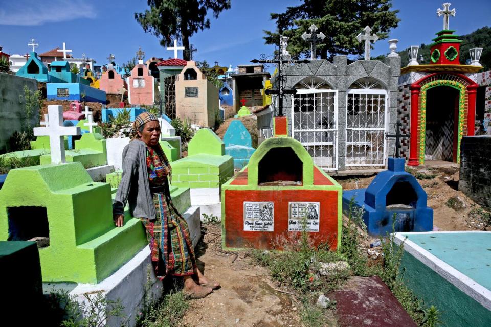 Angela Lopez, 53, visits the gravesite where her husband and son are burried, at the Cementerio General, Comitancillo