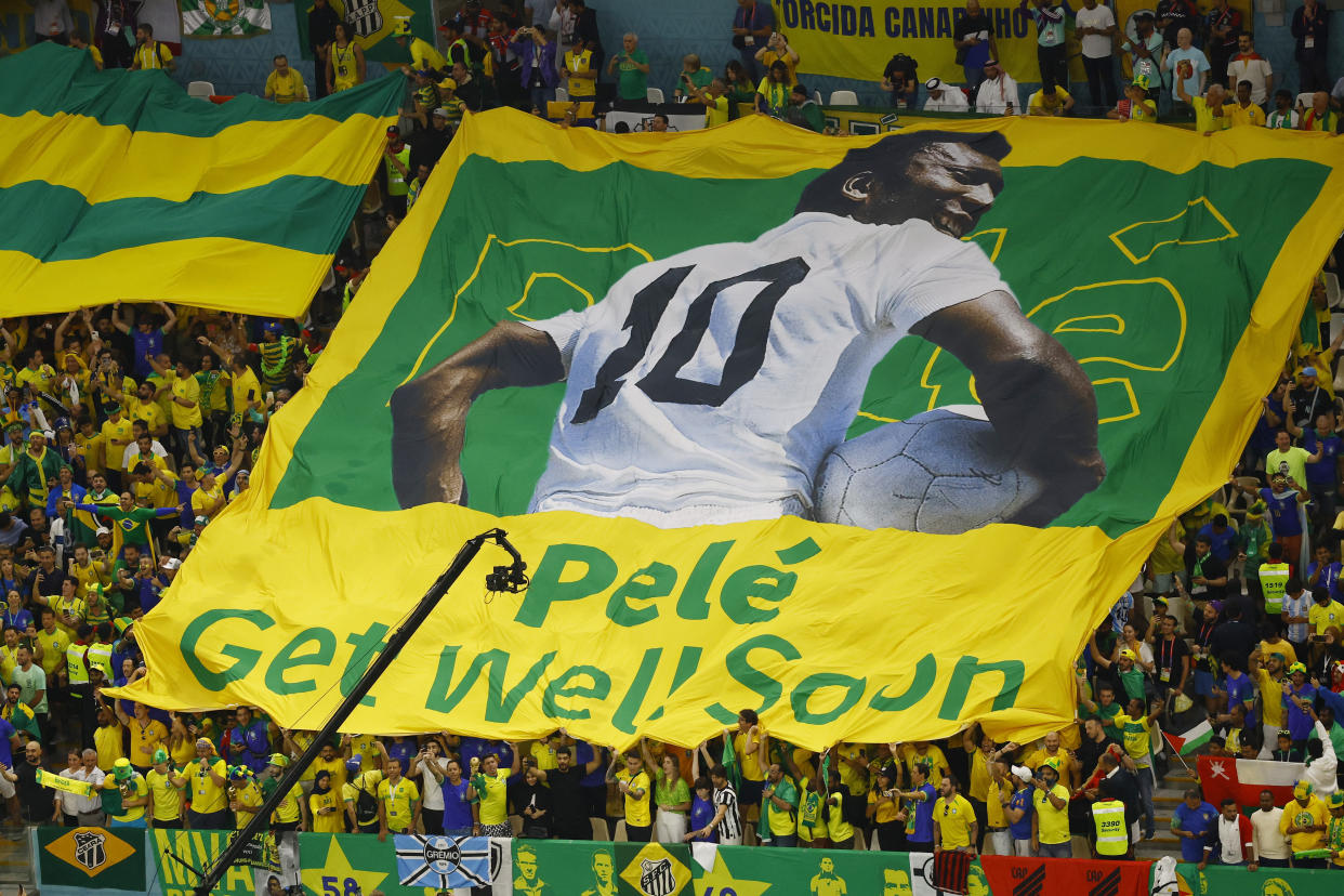 Soccer Football - FIFA World Cup Qatar 2022 - Group G - Cameroon v Brazil - Lusail Stadium, Lusail, Qatar - December 2, 2022 Brazil fans display a banner with an image of former player Pele on it before the match REUTERS/Peter Cziborra