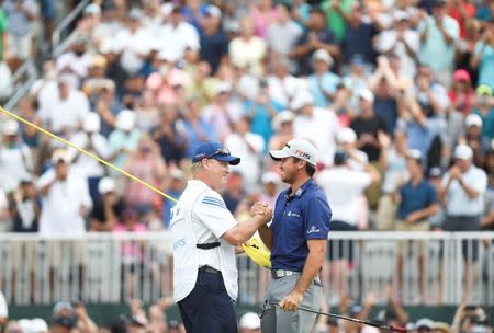 Aug 30, 2015; Edison, NJ, USA; Jason Day celebrates with his caddie Colin Swatton after making a birdie putt at the 18th green at Plainfield Country Club. Day won with a final round of 8-under 62. Mandatory Credit: Eric Sucar-USA TODAY Sports