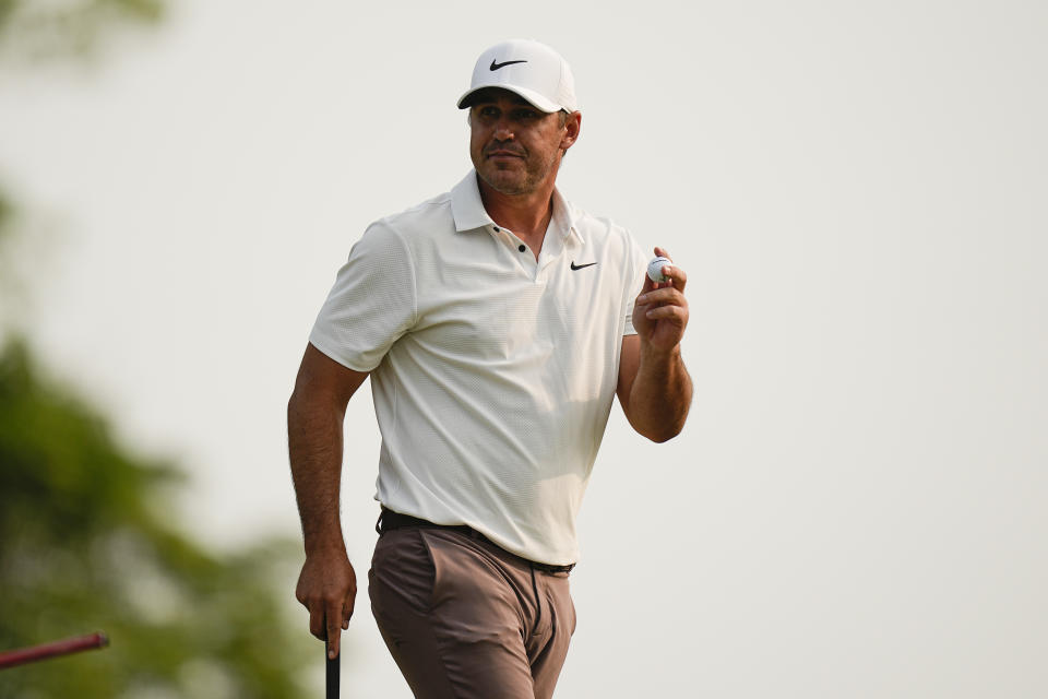 Brooks Koepka waves after his putt on the 15th hole during the final round of the PGA Championship golf tournament at Oak Hill Country Club on Sunday, May 21, 2023, in Pittsford, N.Y. (AP Photo/Eric Gay)