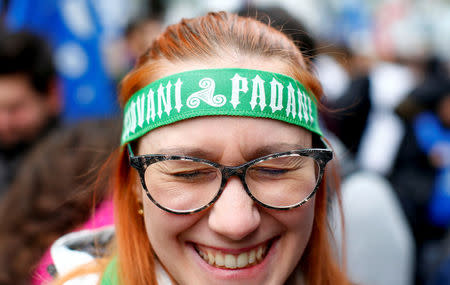 Italian Northern League supporter reacts as she wears a headband reading "Padana youngsters" during a political rally led by leader Matteo Salvini in Milan, Italy February 24, 2018. REUTERS/Tony Gentile