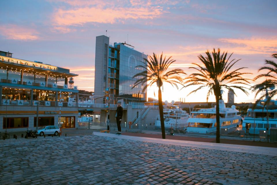 The Barcelona cruise port is a popular stop in Europe, learn more about the terminals and layout. 
Pictured: a metropolitan area of Barcelona with yachts docked nearby 