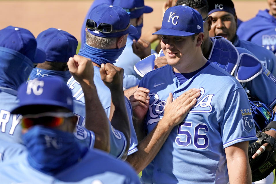 Kansas City Royals starting pitcher Brad Keller (56) celebrates with teammates after their baseball game against the Pittsburgh Pirates Sunday, Sept. 13, 2020, in Kansas City, Mo. Keller pitched a complete game and shut out the Pirates. (AP Photo/Charlie Riedel)