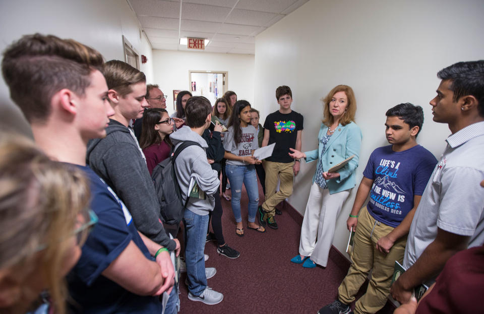 <p>Florida Rep. Kristin Jacobs talks with student survivors from Marjory Stoneman Douglas High School in the hallway at the Florida Capitol in Tallahassee, Fla., Feb 21, 2018. The students from Marjory Stoneman Douglas High School are in town to lobby the Florida Legislature after a shooting that left 17 dead at their school. (Photo: Mark Wallheiser/AP) </p>