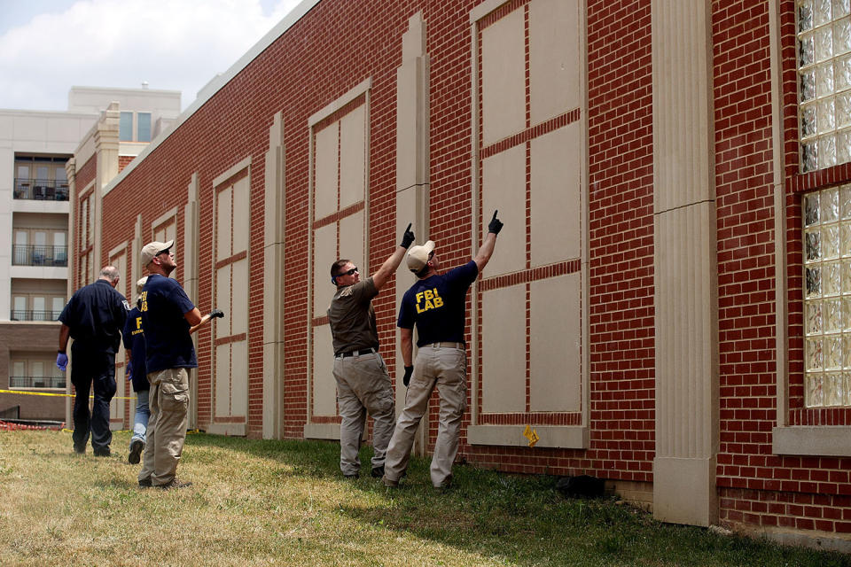 <p>Members the FBI survey the damages possibly caused by gun shots on a wall at the site of this morning’s shooting at Eugene Simpson Stadium Park, June 14, 2017 in Alexandria, Va. (Photo: Alex Wong/Getty Images) </p>