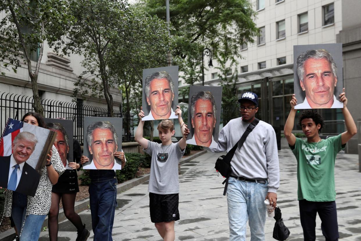 Demonstrators hold photos aloft protesting Jeffrey Epstein in New York.JPG