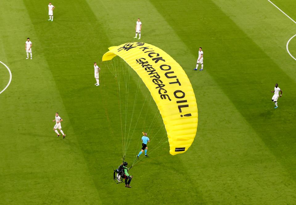 The activist from Greenpeace had the words “Kick out oil Greenpeace” written on his parachute (AP)