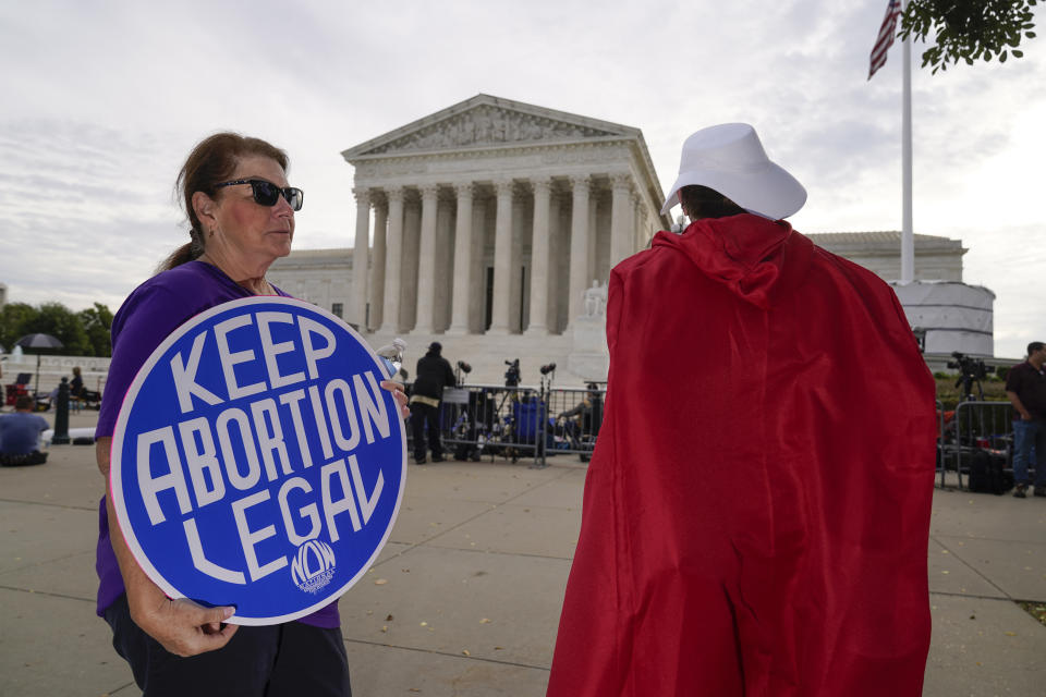 The Supreme Court is seen on the first day of the new term as activists demonstrate on the plaza, in Washington, Monday, Oct. 4, 2021. Arguments are planned for December challenging Roe v. Wade and Planned Parenthood v. Casey, the Supreme Court's major decisions over the last half-century that guarantee a woman's right to an abortion nationwide. (AP Photo/J. Scott Applewhite)