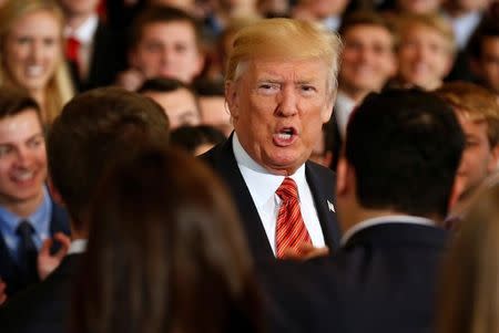 U.S. President Donald Trump speaks to departing White House interns after posing for a photograph with them in the East Room of the White House in Washington, U.S., July 24, 2017. REUTERS/Joshua Roberts