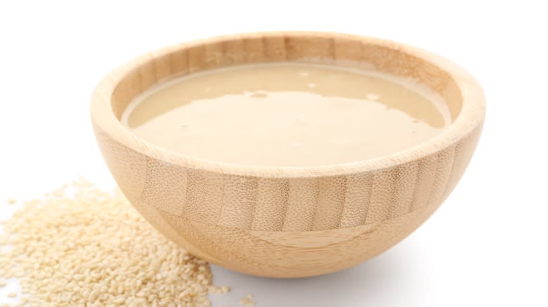 Tahini sauce in wooden bowl