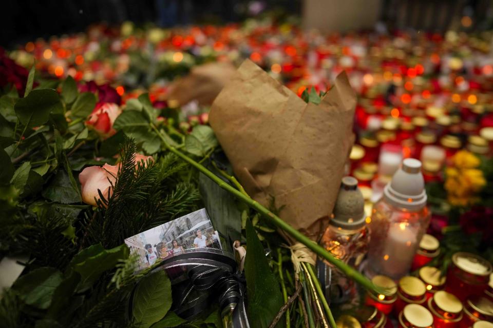Tributes are placed outside the headquarters of Charles University for the victims of mass shooting in Prague, Czech Republic, Friday, Dec. 22, 2023. A lone gunman opened fire at a university on Thursday, killing more than a dozen people and injuring scores of people. in downtown Prague, Czech Republic, Friday, Dec. 22, 2023. (AP Photo/Petr David Josek)
