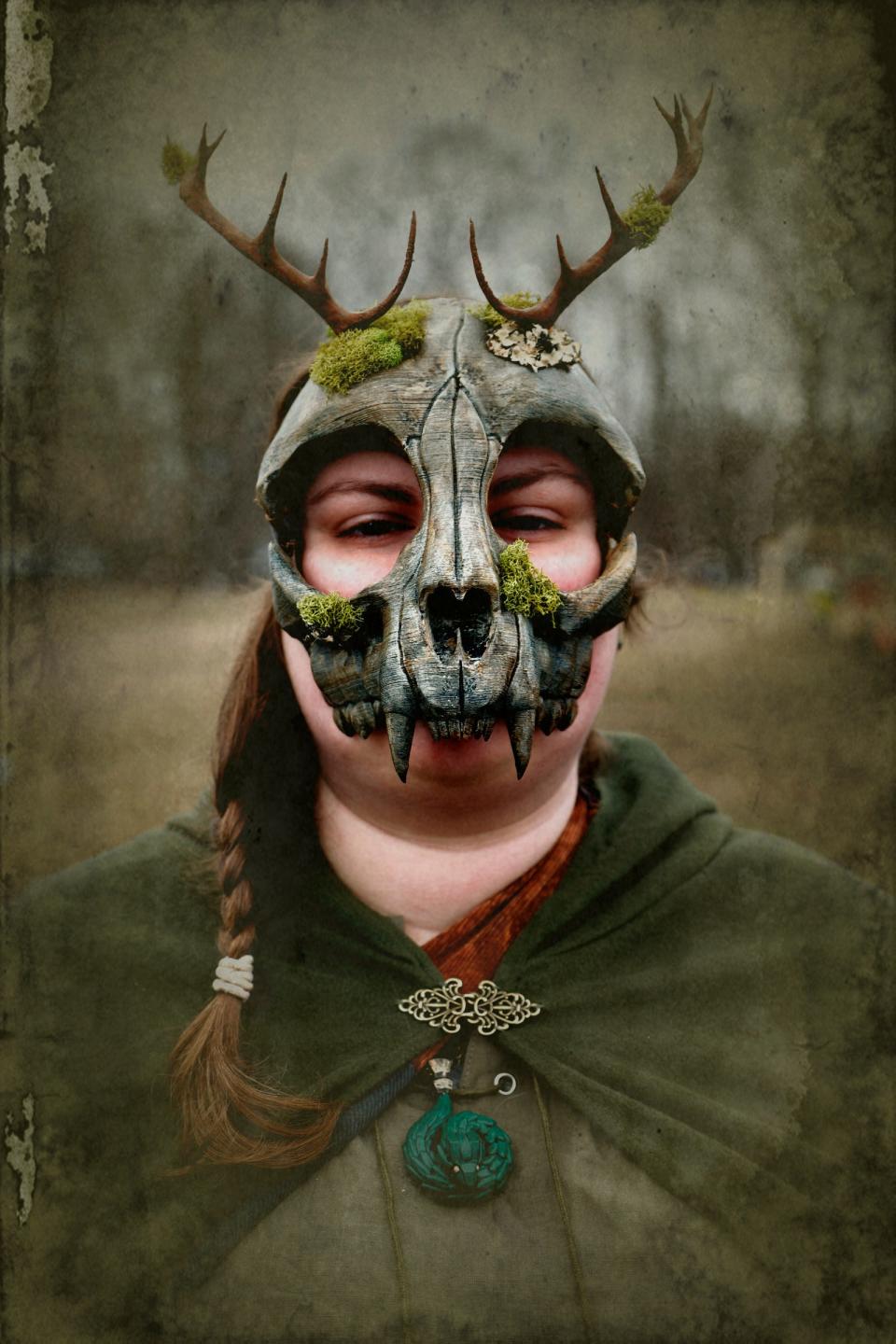 Veronica Vandenberg, 23, of Bay City, with her deer skull and moss mask that she wore during the Michigan Nordic Fire Festival at the Eaton County Fairgrounds in Charlotte on Saturday, Feb. 25, 2023.