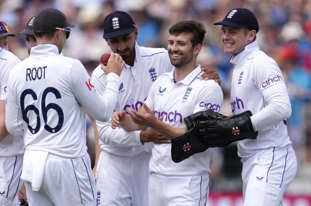 Mark Wood celebrates a wicket with his England team-mates