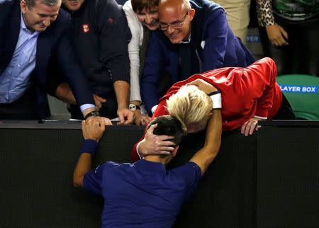 Serbia's Novak Djokovic (bottom) celebrates with his coach Boris Becker after winning his final match against Britain's Andy Murray at the Australian Open tennis tournament at Melbourne Park, Australia, January 31, 2016. REUTERS/Tyrone Siu