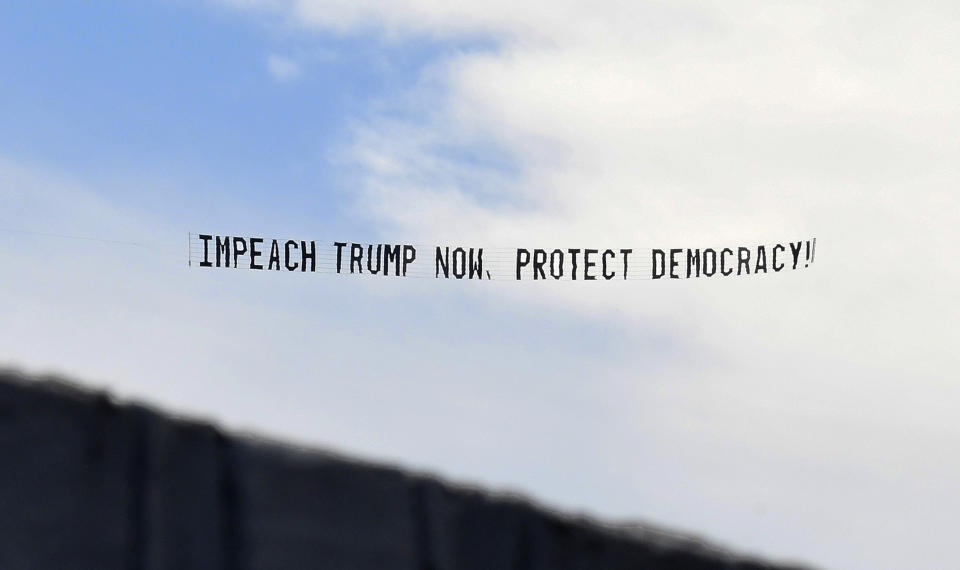 ORLANDO, FLORIDA, UNITED STATES - 2021/01/07: A banner towed by a plane calls for the impeachment of U.S. President Donald Trump. 
A day after a pro-Trump mob stormed the U.S. Capitol, members of the House Judiciary Committee have announced articles of impeachment for President Donald Trump, alleging he will remain a threat to national security, democracy and the Constitution if he is allowed to remain in office for two more weeks. (Photo by Paul Hennessy/SOPA Images/LightRocket via Getty Images)