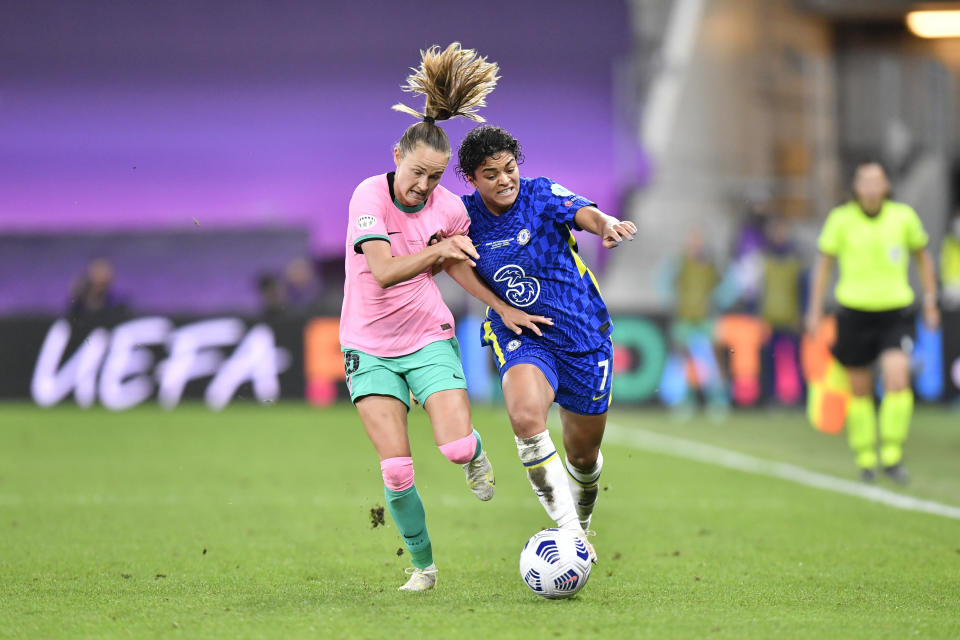 Barcelona's Caroline Graham Hansen, left, fights for the ball with Chelsea's Jessica Carter during the UEFA Women's Champions League final soccer match between Chelsea FC and FC Barcelona in Gothenburg, Sweden, Sunday, May 16, 2021. (AP Photo/Martin Meissner)