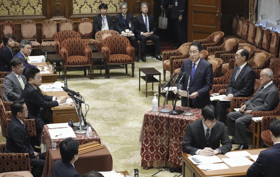 Japanese Prime Minister Fumio Kishida raises his hand before he speaks about his Liberal Democratic Party's funds scandal during a meeting of the Lower House Budget Committee in Tokyo Monday, Jan. 29, 2024. Kishida on Monday was forced to start this year's parliamentary session with an apology over one of the country's biggest corruption scandals in decades. (Kyodo News via AP)