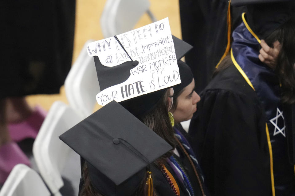 A student wears a message to protest Former U.S. Rep. Liz Cheney, R-Wyo., delivering the commencement address at Colorado College, Sunday, May 28, 2023, in Colorado Springs, Colo. (AP Photo/Jack Dempsey)