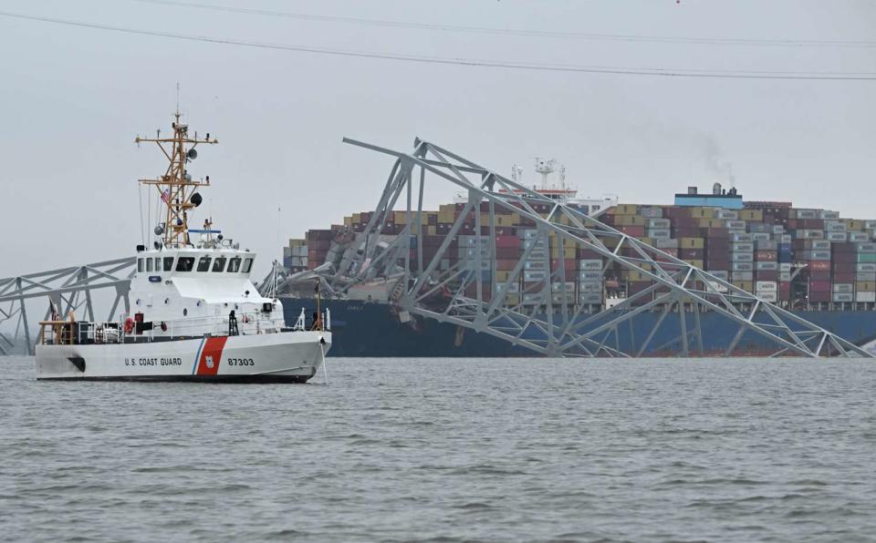 <p>JIM WATSON/AFP via Getty</p> The US Coast Guard Cutter Mako patrols near the collapsed Francis Scott Key Bridge after it was struck by the container ship Dali in Baltimore, Maryland, on March 27, 2024.