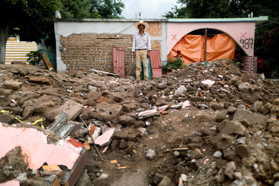 <p>Miguel Najera, 50, a farm worker, poses for a portrait on the rubble of his house after an earthquake in San Jose Platanar, at the epicentre zone, Mexico, September 28, 2017. The house was very badly damaged, but with the help of his family Najera was able to rescue some furniture. He is living in another room of his house and hopes to repair the damage as soon as possible. “I hope that together with my family we will get ahead, I have brothers in the U.S. and I hope they can help me,” Najera said. (Photo: Edgard Garrido/Reuters) </p>