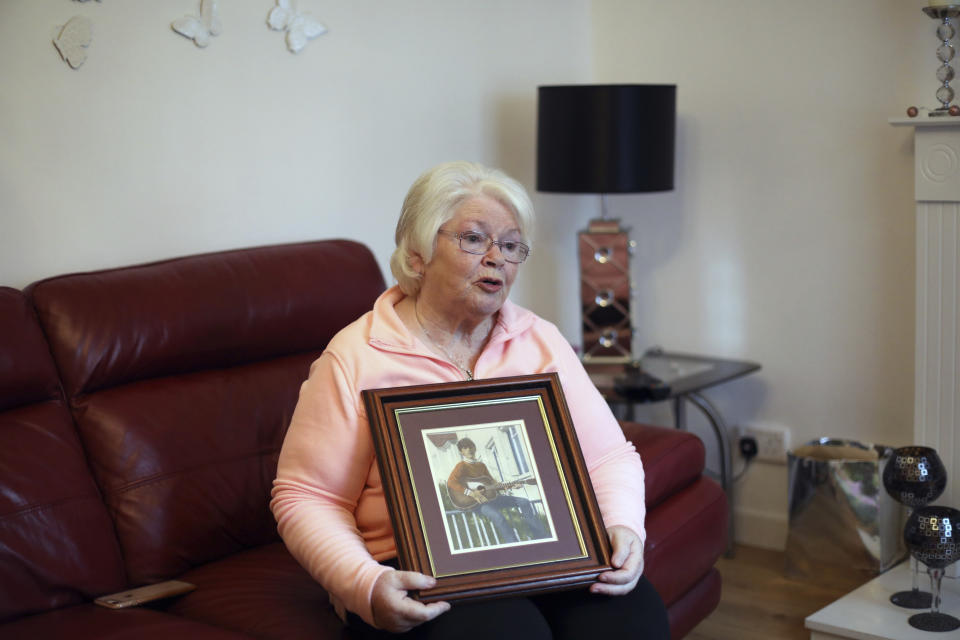 In this photo dated Monday Oct. 14, 2019 Kate Nash holds a picture of her brother William at home in the Glendora area of Londonderry, Northern Ireland. Nash, a 70-year-old grandmother who lost her brother William in what became known as Bloody Sunday, fears, Brexit may cause the smoldering conflict in Northern Ireland to flare up once again, especially if there are renewed customs and passport controls along the border between the Republic of Ireland and the U.K.'s Northern Ireland. (AP Photo/Peter Morrison)