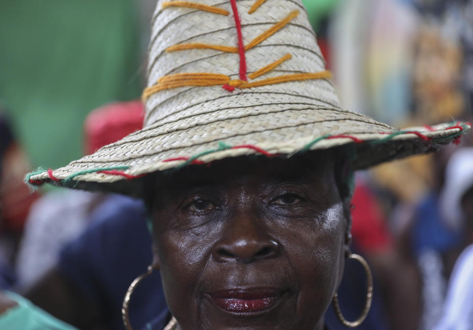 FILE - A vodou pilgrim attends a Mass marking the feast day of agriculture and work, in Port-au-Prince, Haiti, May 1, 2024. The syncretic religion that melds Catholicism with animist beliefs has no official leader or creeds. (AP Photo/Odelyn Joseph, File)
