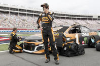 Kurt Busch talks on his phone before the start of the NASCAR Cup Series auto race at Charlotte Motor Speedway Sunday, May 24, 2020, in Concord, N.C. (AP Photo/Gerry Broome)