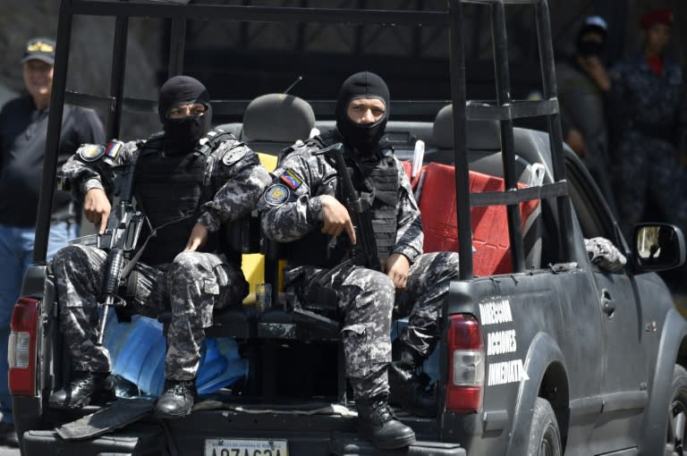 Venezuelan security forces are seen at the entrance of the intelligence service's Helicoide center in Caracas after opposition figures took control of a part of it