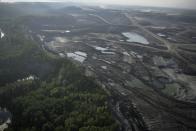 Trees line Suncor's oil sands operation near Fort McMurray, Canada, on Friday, Sep. 1, 2023. Extraction from this area, referred to as the "oil sands," uses huge amounts of energy, making Canada's oil — most of which is extracted here — some of the world's dirtiest. (AP Photo/Victor R. Caivano)