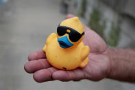 <p>A volunteer holds a rubber duck recovered from the Chicago River following the Windy City Rubber Ducky Derby on August 3, 2017 in Chicago, Illinois. (Photo: Scott Olson/Getty Images) </p>