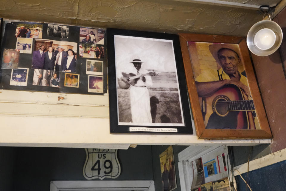 Portraits of Henry Stuckey, the originator of the Bentonia blues, second from right, and area resident and bluesman Jack Owens, hang high on the wall at the Blue Front Cafe in Bentonia, Miss., Jan. 21, 2021. Blues performer Jimmy "Duck" Holmes credits both Stuckey and Owens for having influenced his adoption of the Bentonia style of blues playing. Holmes' ninth album, "Cypress Grove," has earned a Grammy nomination for the Best Traditional Blues Album. (AP Photo/Rogelio V. Solis)